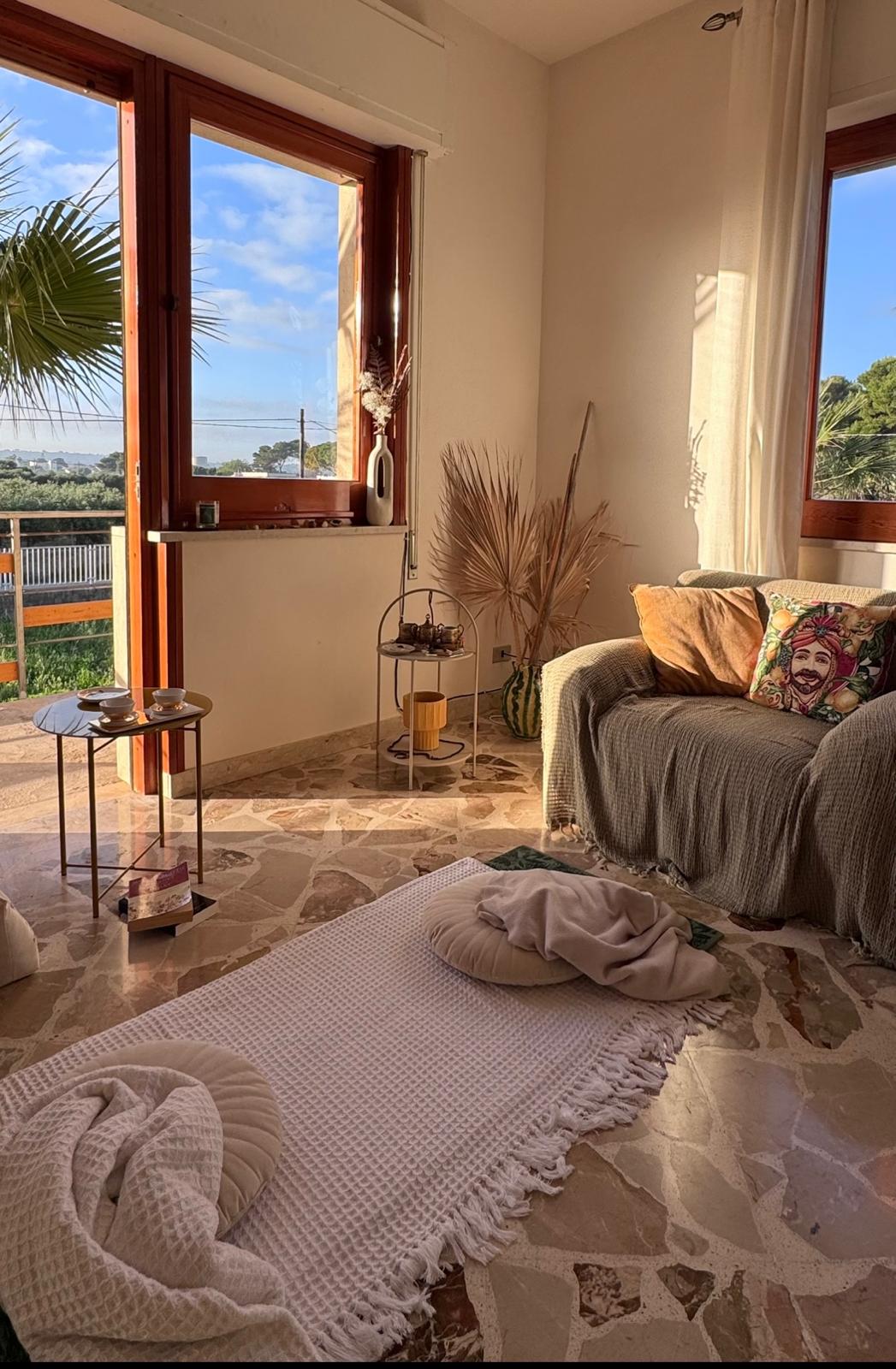 La Villa Organica — ceremony space with Sicilian textiles and golden light